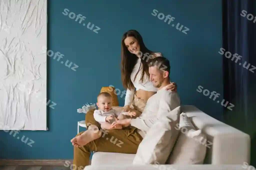 Baxtli oila ona, baba, bolaga birgalikda uyda ko'k xona, oq derazón bilan. | Happy family mother father with child home blue room with white sofa