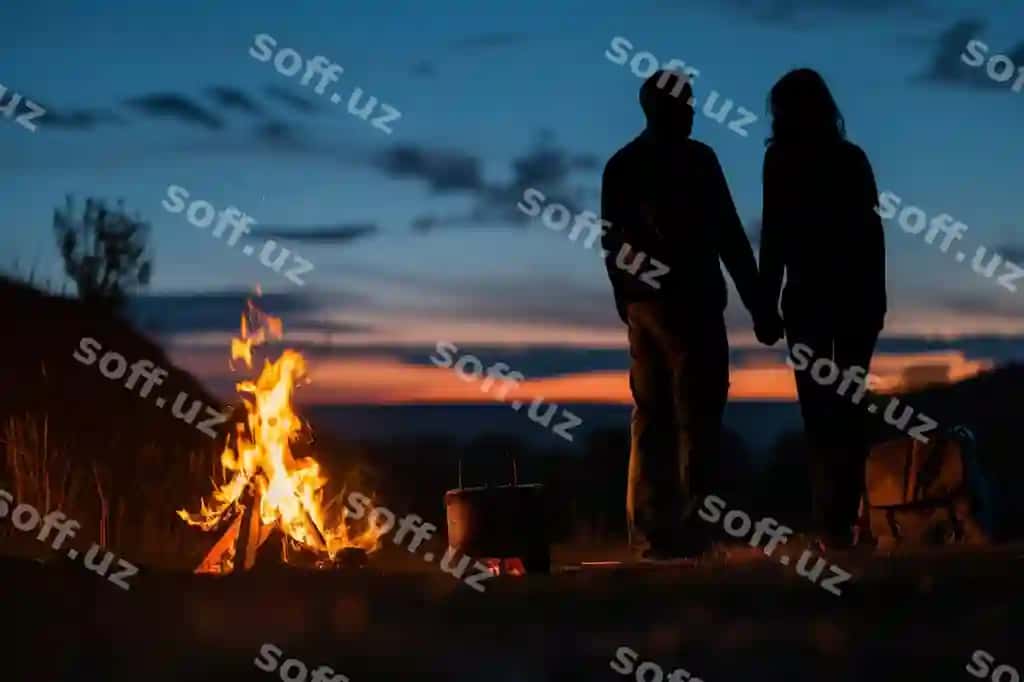 Siluetdagi juftlik kempovkada kechki soatlar davomi qo'llarini tutgan holda | Silhouetted couple holding hands by campfire dusk