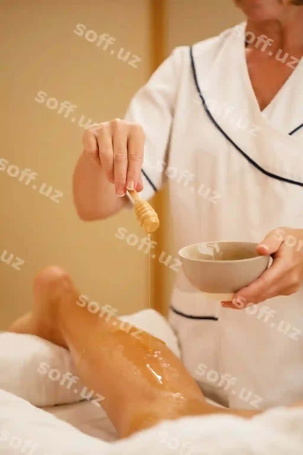 Salomatlik spa da ayolning oyoqini baldan foydalangan holda massaj qiluvchi tanish emas massajist | Unrecognizable therapist using honey while massaging woman s leg health spa